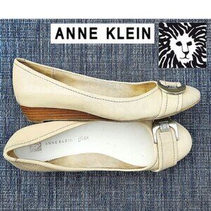 Anne Klein iflex low wedge flats in cream with front monogram buckle
